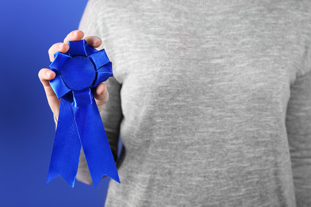 Woman with award ribbon. close-up
