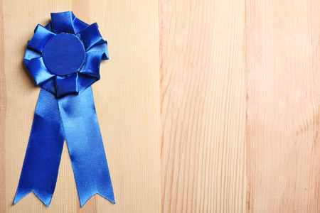 Award ribbon on wooden backgroundの写真素材