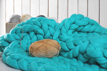 Knitted wool plaid  and clothes on light backgroundの写真素材