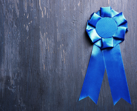 Award ribbon on wooden backgroundの写真素材