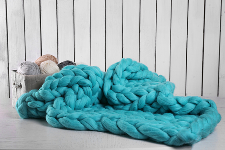 Knitted wool plaid  and clothes on light backgroundの写真素材