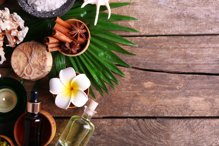 Beautiful spa setting on palm leaf on wooden tableの写真素材