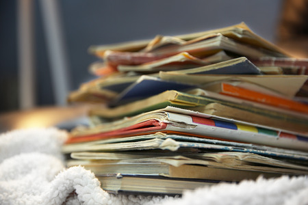 Pile of books on leather chair in the room, close upの写真素材