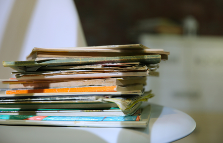 Pile of old books on white chair, close upの写真素材