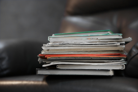 Pile of books on leather chair in the room, close upの写真素材