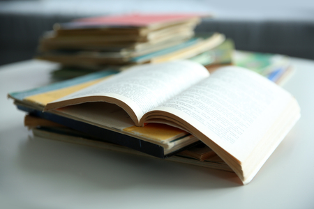 Pile of old books on white table, close upの写真素材