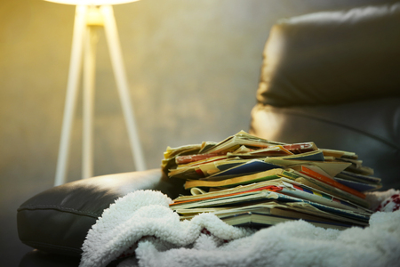 Pile of books on leather chair in the room, close upの写真素材