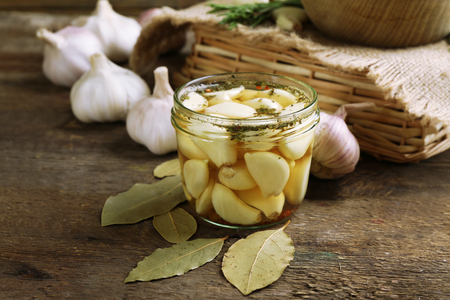 Garlic with spices on wooden tableの写真素材