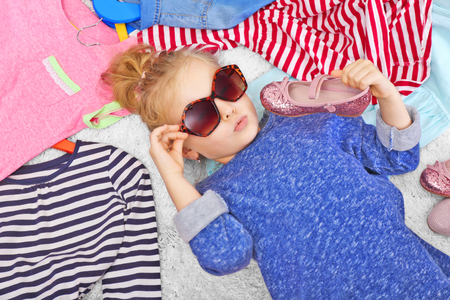 Little girl and new clothes, top viewの写真素材
