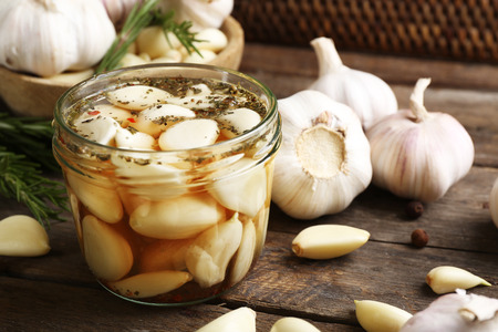 Garlic with spices on wooden tableの写真素材