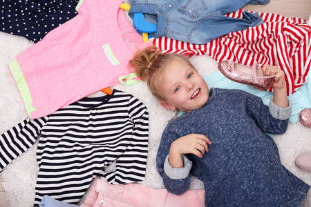 Little girl and new clothes, top viewの写真素材