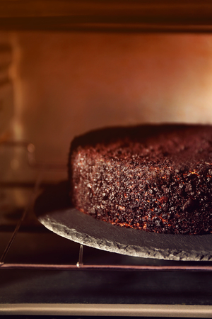 Chocolate cake in oven, close upの写真素材