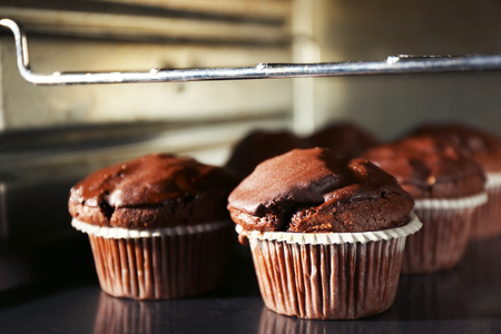 Chocolate cup-cakes in oven, close upの写真素材