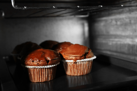 Chocolate cup-cakes in oven, close upの写真素材