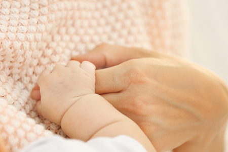 Woman and baby's hands, close upの写真素材