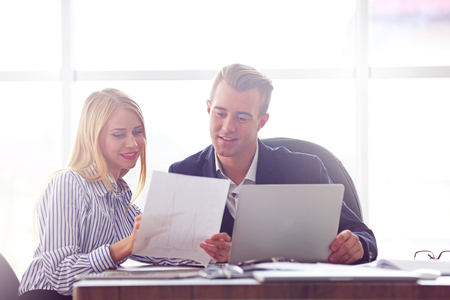 Businessman and businesswoman working in officeの写真素材