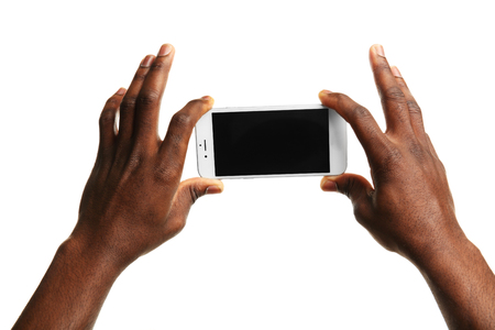 Hand holding mobile smart phone with blank screen, isolated on whiteの写真素材