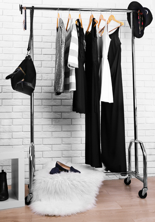 Collection of male and female clothes hanging on a rackの写真素材