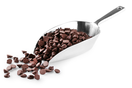 Chocolate morsels in scoop isolated on whiteの写真素材