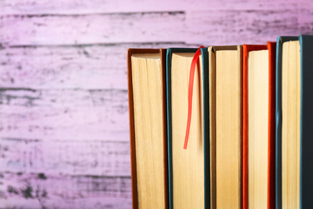 Pile of books on wooden backgroundの写真素材