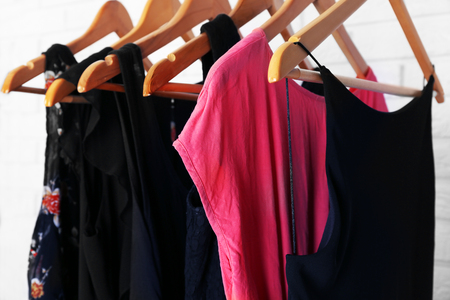 Collection of female clothes hanging on a rackの写真素材