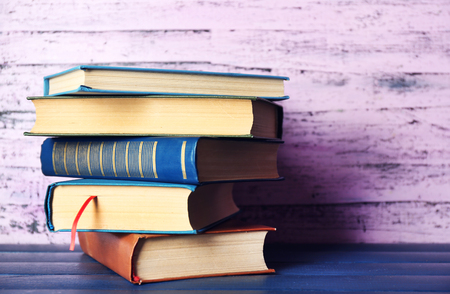 Pile of books on wooden backgroundの写真素材