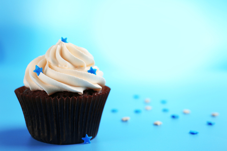 Chocolate cupcake on blue backgroundの写真素材
