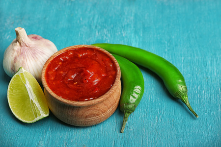 Homemade sauce salsa and spices on color wooden backgroundの写真素材