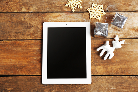 Tablet and Christmas decor on wooden backgroundの写真素材