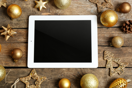 Tablet and Christmas decor on wooden backgroundの写真素材