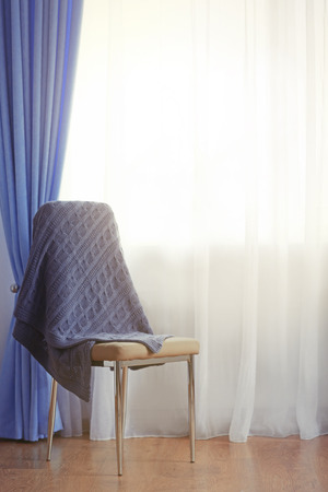 Chair in the room near the window with curtainsの写真素材