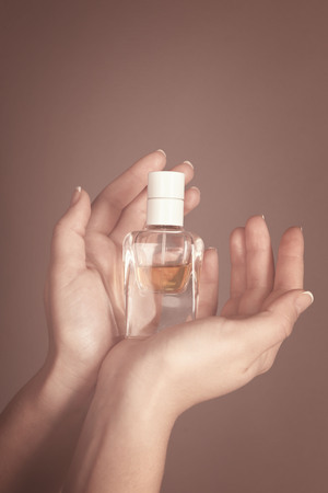 Young woman holding bottle perfumeの写真素材
