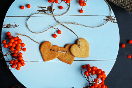 Heart shaped biscuits with ash berries on a round mat, top viewの写真素材