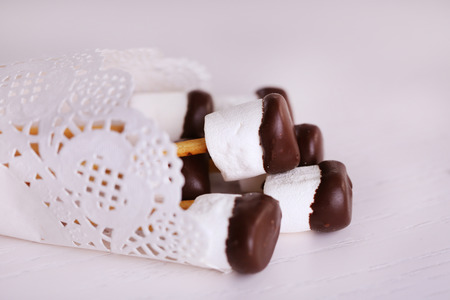 Tasty marshmallows with chocolate on sticks, close upの写真素材