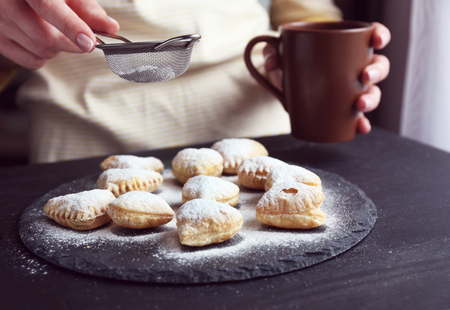 Cook is powdering heart shaped biscuitsの写真素材