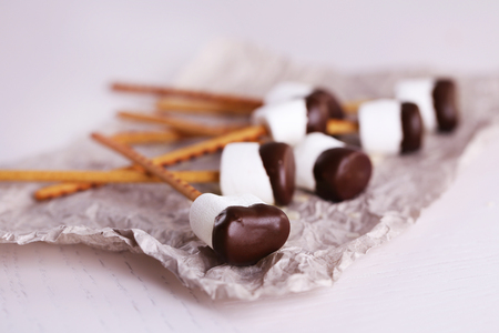 Tasty marshmallows with chocolate on sticks, close upの写真素材
