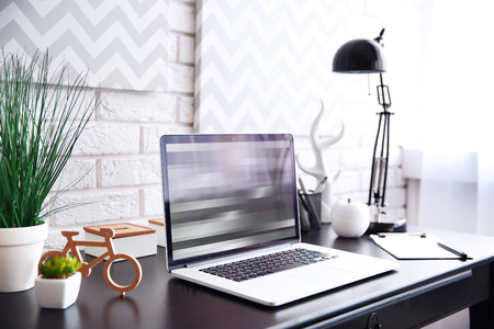 Workplace with laptop on table at homeの写真素材