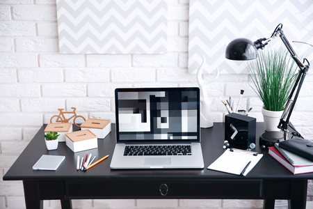 Workplace with laptop on table at homeの写真素材