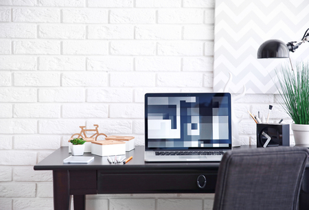 Workplace with laptop on table at homeの写真素材