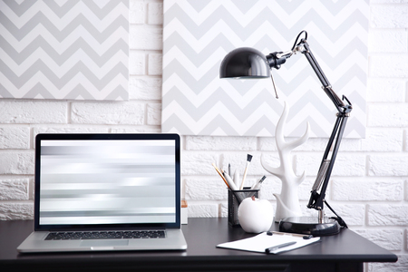 Workplace with laptop on table at homeの写真素材