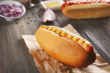 Hot dog on craft paper on wooden backgroundの写真素材