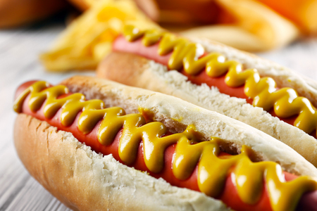 Hot dogs with cheese on wooden backgroundの写真素材