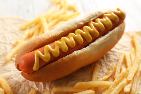 Hot dog and fried potatoes on wooden backgroundの写真素材