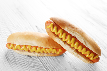 Two hot dogs on wooden backgroundの写真素材