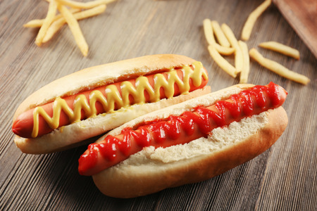 Hot dogs with fried potatoes on wooden backgroundの写真素材