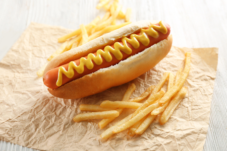 Hot dog and fried potatoes on wooden backgroundの写真素材