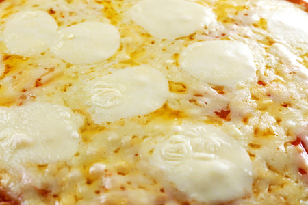 Pizza full of cheese backgroundの写真素材