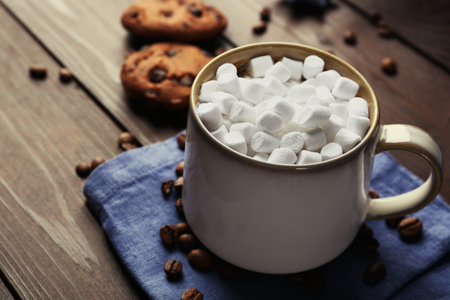 Mug of hot chocolate with marshmallows, on wooden backgroundの写真素材
