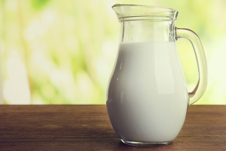 Jar of milk on blurred natural backgroundの写真素材