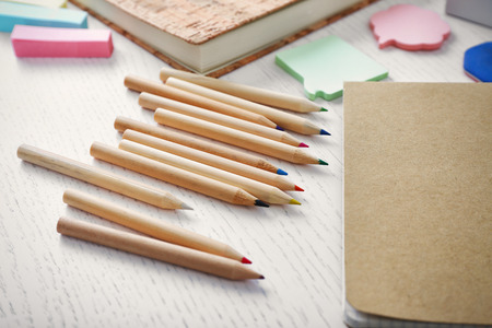 Notebooks with stationery on a white tableの写真素材